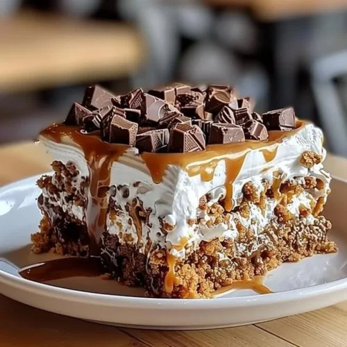 Delicious Heath Bar Poke Cake topped with crushed Heath bars and whipped cream