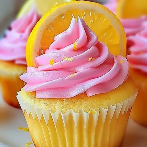 Delicious pink lemonade cupcakes with frosting and lemon slices on top