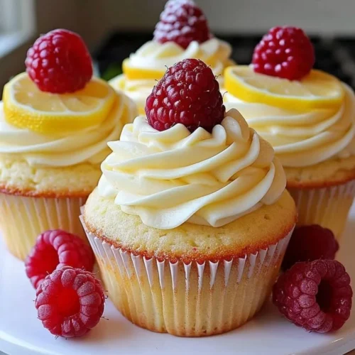 Delicious Raspberry Lemon Cupcakes topped with fresh raspberries and lemon zest.