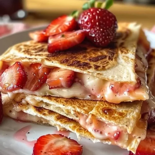 Delicious sweet strawberry cheesecake quesadillas on a plate